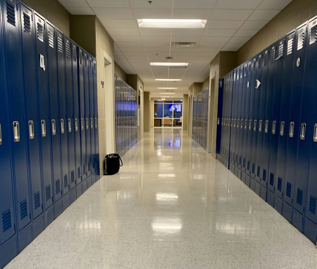 An empty school hall in Edmonton with floors that were cleaned by Greg Mat's Cleaning who offers commercial Edmonton cleaning services.